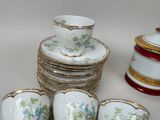 a lot of cups and saucers sitting on a table