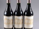 three bottles of wine sitting on top of a table next to each other