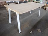 a white table with a wooden top in a room