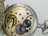a person holding a pocket watch in their hand