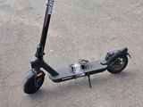 a scooter that is sitting on the ground in the parking lot