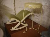 a yellow rocking chair and a small table in a room