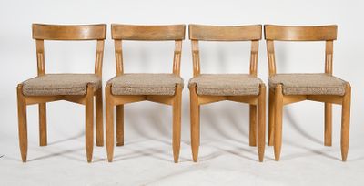 three wooden chairs sitting next to each other on a white surface