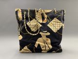 black and gold tote bag with gold chain handles and gold chain handles