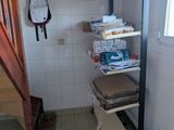 a bathroom with a toilet and a shelf in it