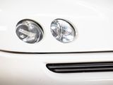 a close up of a car ' s headlight on a white car
