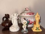 many figurines sitting on a table with a vase