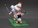 figurine of a cat playing golf on a green surface