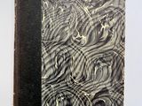 un vieux livre orné de volutes noires et blanches