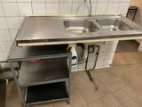 a sink and a shelf in a small kitchen