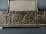 an old wooden box with a carving of a man and a woman on it