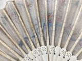a fan that has a picture of a woman on it