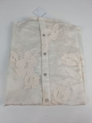 the back of a white shirt with a floral design on it