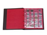 an open red book with a bunch of coins inside of it