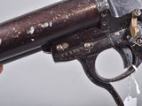 a person holding a gun that has a bullet in it