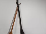 pair of wooden paddles and a wooden paddle on a white surface