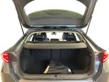 the back of a car with its trunk open and luggage in the trunk