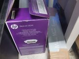 a purple box sitting on top of a desk next to a computer monitor