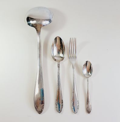 a spoon, fork, spoon and spoon rest on a table