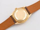 rolex a gentleman ' s 18k gold wristwatch with brown leather strap