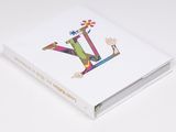 a white book with the letter l on it sitting on a table