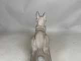 an image of a statue of a dog sitting on top of a wooden block