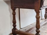 a wooden table with a drawer on top of it