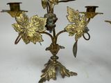 brass candelab with grapes and leaves on it on a white background