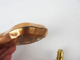 a person holding a brass object in their hand