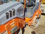 a small orange and black machine that is sitting in the dirt