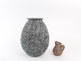 two vases sitting next to each other on a white surface