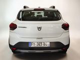 the rear end of a white car is shown in a studio setting