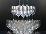 a lot of wine glasses stacked on top of each other