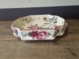 a small tray with flowers on it sitting on a wooden table