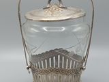 un bocal en verre ancien plaqué argent, muni d'une poignée et d'un couvercle
