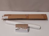 a white pen sitting on a table next to a cardboard box