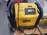 a yellow machine that is sitting on a pallet