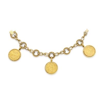 a gold necklace with coins and charms on a chain