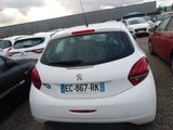 a white car parked in a parking lot next to other cars
