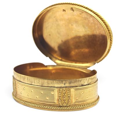 a small gold box with a lid on a white surface
