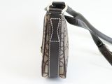 the back view of a brown and black purse with a black strap