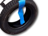 a tire with a blue tape on the side of it