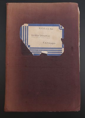 un vieux livre posé sur une table à côté d'une table noire