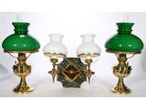 three green glass lamps sitting next to each other on a table