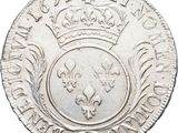 a close up of a silver coin with a crown on it