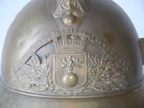 a metal helmet with a coat of arms and a crown on it