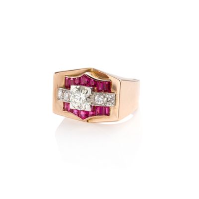 a close up of a diamond and ruby ring on a white background