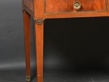an antique writing table with a brass plated top