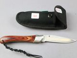 a knife and a sheath on a table next to each other