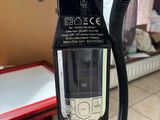 a vacuum that is sitting on the floor in the room